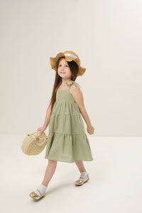 Maxi dress with ties for kids, featuring a flowy design and adjustable ties for a perfect fit